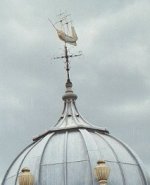 a wind vane with a ship model