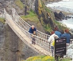 a boy with his grandfather crossing Rope Bridge 