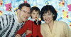 Family in Sara's room by Winnie the Pooh curtain. 1999/12. (7.jpg 77k)